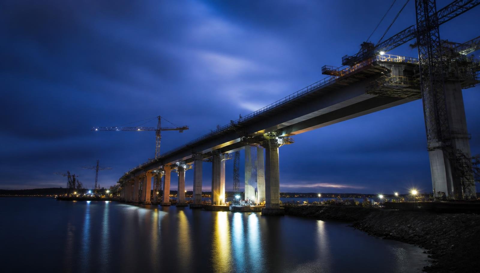 Bridge infrastructure project under construction at blue hour